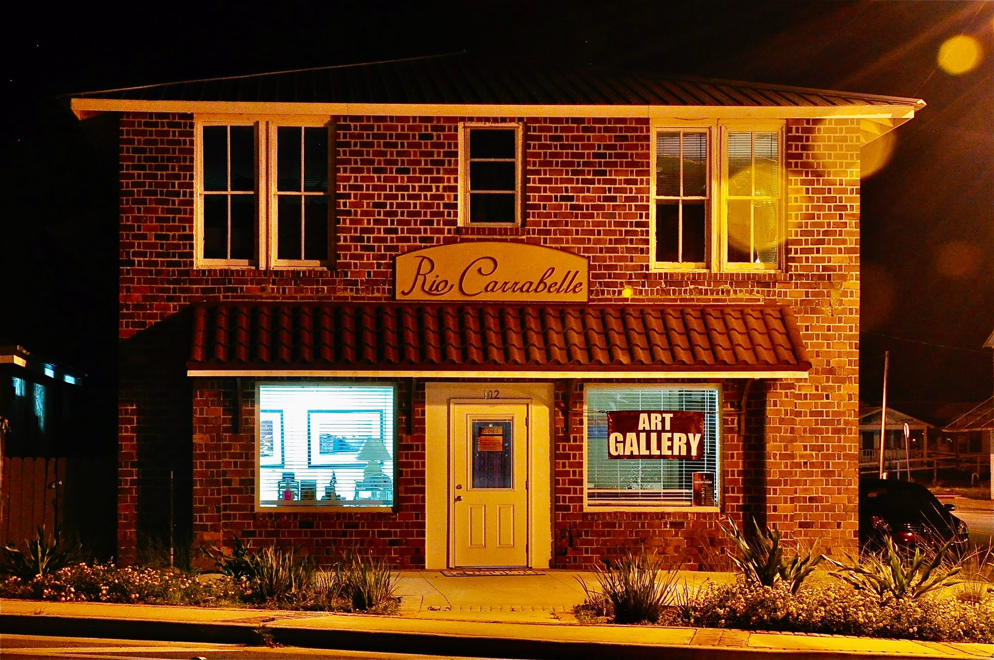 Front of a two story brick building at night